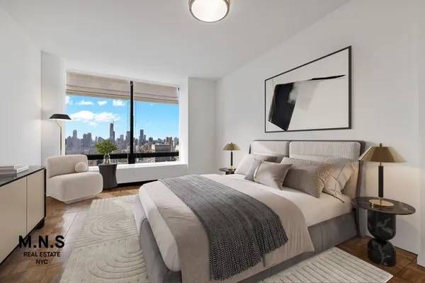 a bedroom with bed and a large window