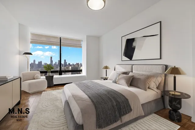 a bedroom with bed and a large window