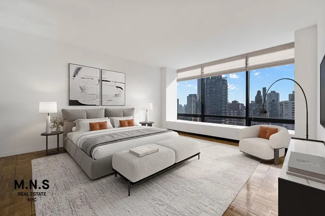 a bedroom with a bed and a large window