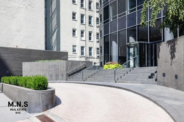 a building outdoor space with patio furniture and potted plants