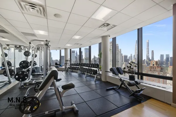 a living room with lots of gym equipment