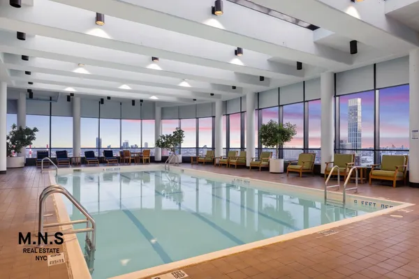 a kitchen with a large window cabinets and stainless steel appliances