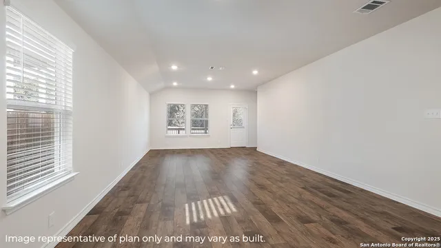 a view of an empty room and a window