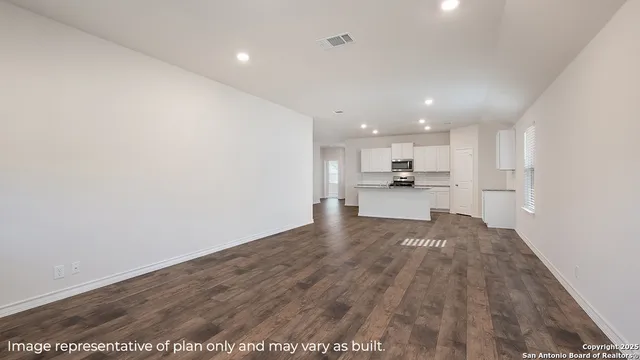 a view of kitchen with kitchen island a sink wooden floor and kitchen view