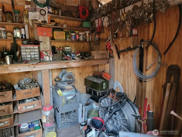a utility room with lots of clutter and cabinets