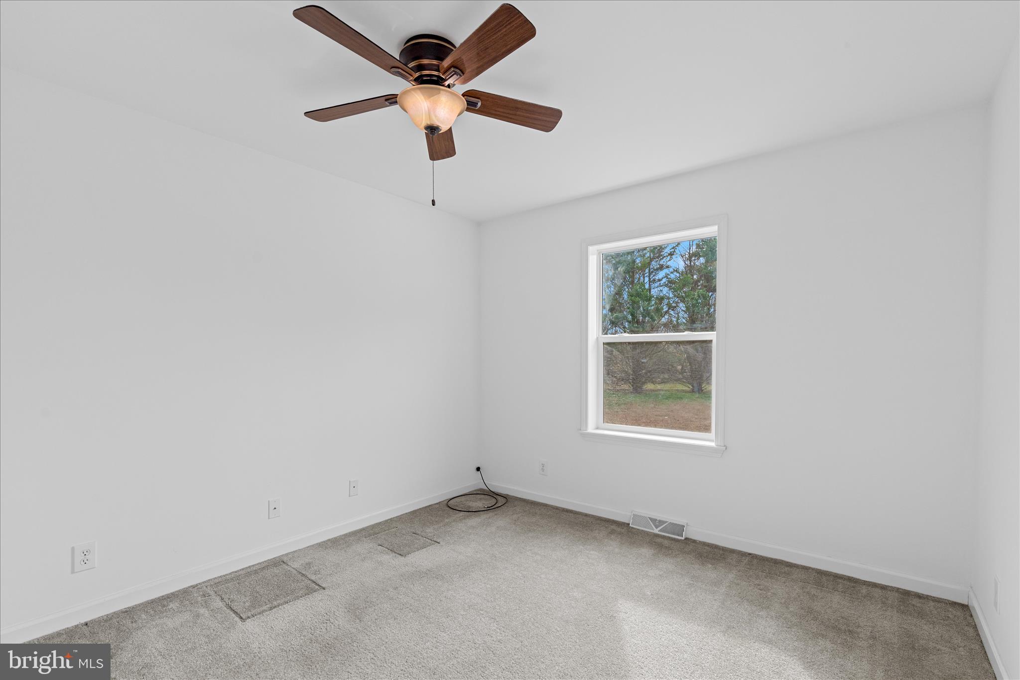 12454 Mirey Branch Road Laurel, DE 19956 - Photo 29 of 51 an empty room with a window and a fan
