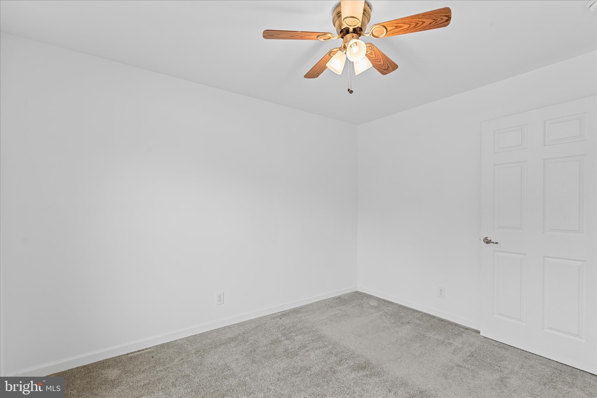 12454 Mirey Branch Road Laurel, DE 19956 - Photo 36 of 51 an empty room with a chandelier fan and wooden floor