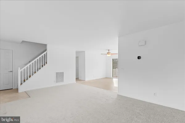 a view of an empty room with stairs