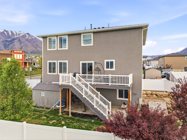 256 West Horizon Loop Payson, UT 84651 - Photo 32 of 33 Back of house with a fenced backyard, a deck with mountain view, stucco siding, a residential view, and a patio