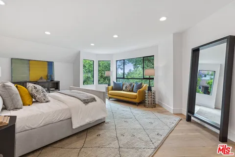 a spacious bedroom with a bed and a couch