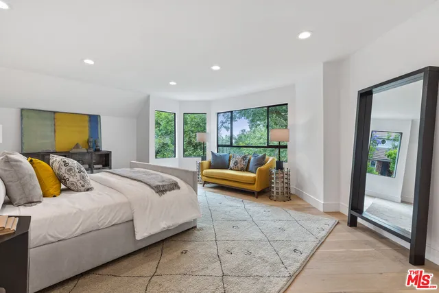 a spacious bedroom with a bed and a couch