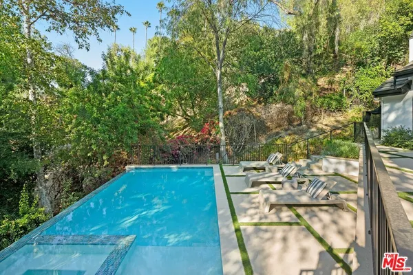 a view of swimming pool with a patio