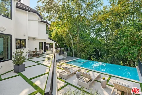 a view of a patio with table and chairs potted plants with wooden fence