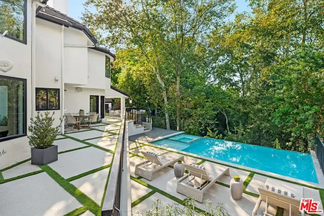 a view of a patio with table and chairs potted plants with wooden fence