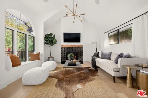 a living room with furniture fireplace and a flat screen tv
