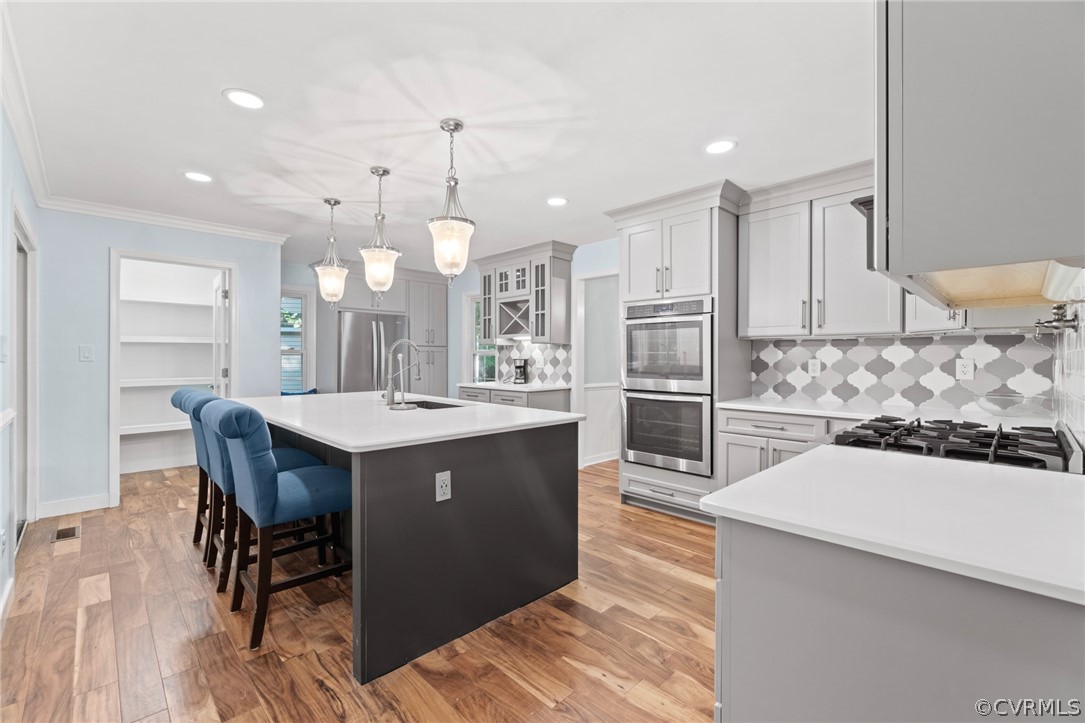 3704 Pease Road Midlothian, VA 23112 - Photo 12 of 50 a kitchen with stainless steel appliances kitchen island granite countertop a table chairs and a refrigerator