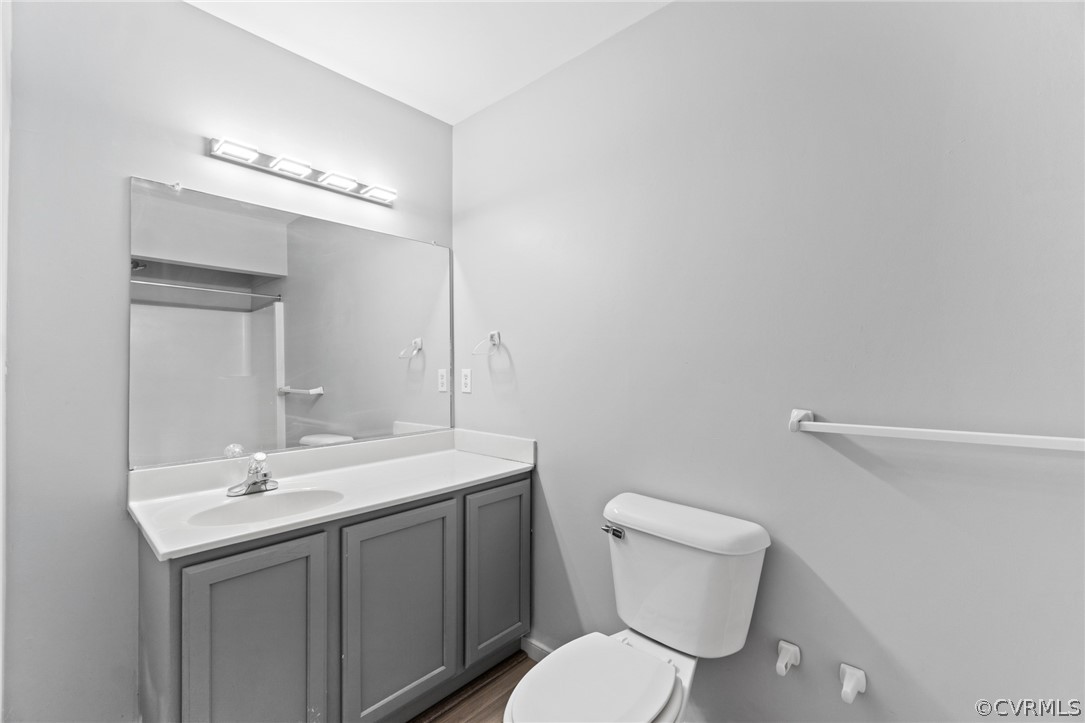 3704 Pease Road Midlothian, VA 23112 - Photo 19 of 50 a bathroom with a toilet a sink a mirror and vanity