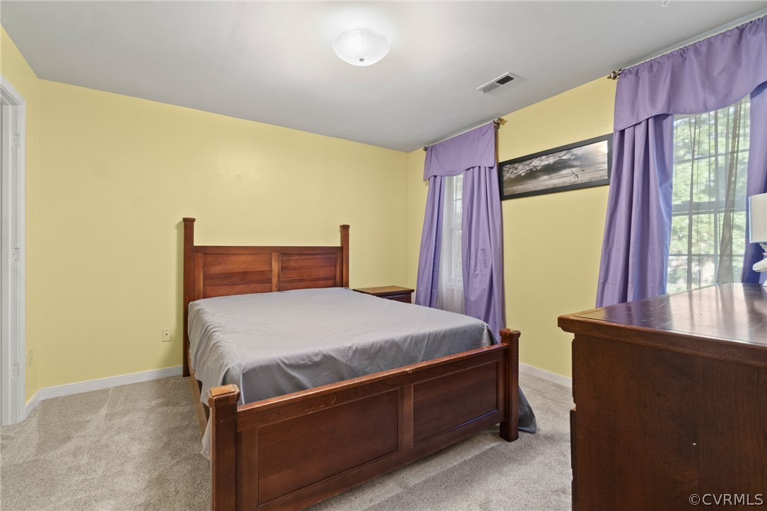 3704 Pease Road Midlothian, VA 23112 - Photo 29 of 50 a bed sitting in a bedroom next to a window