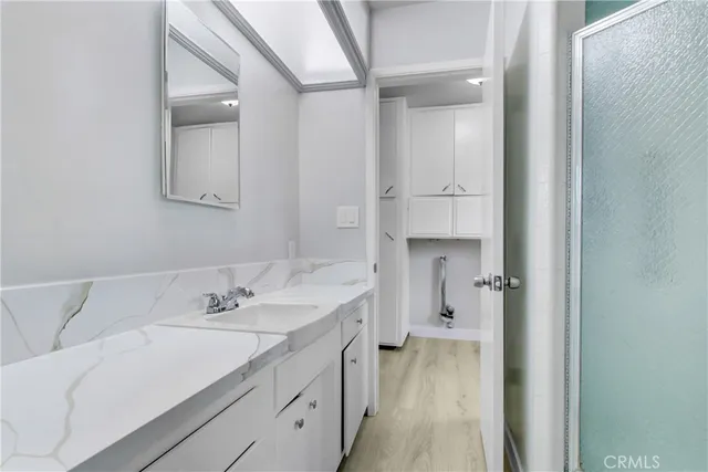 a spacious bathroom with a sink and a mirror
