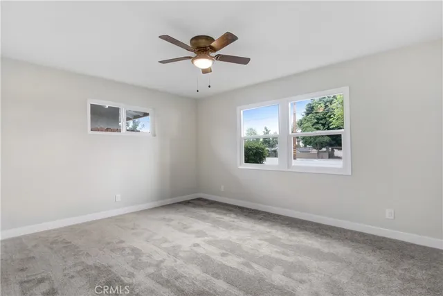 a view of room with window and ceiling fan