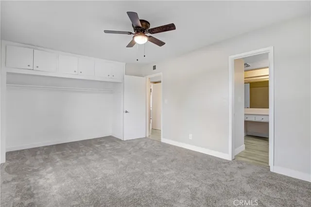 a view of a livingroom with a ceiling fan & a ceiling fan