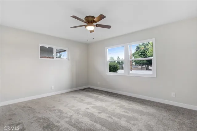 a view of room with window and ceiling fan