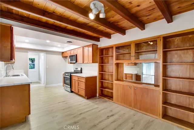 a kitchen with stainless steel appliances granite countertop a stove and a wooden floors