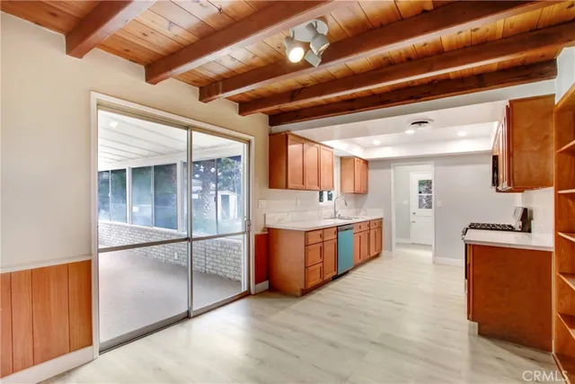 a large kitchen with stainless steel appliances granite countertop a stove a sink and a refrigerator