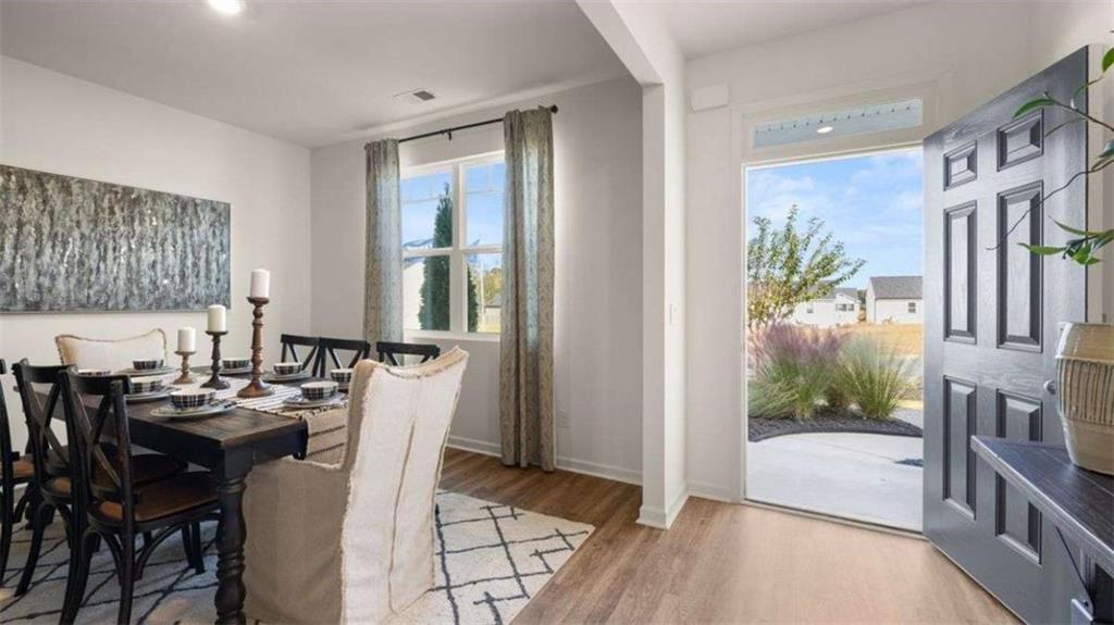 62 White Spruce Way Newnan, GA 30265 - Photo 3 of 41 a view of a dining room with furniture window and wooden floor