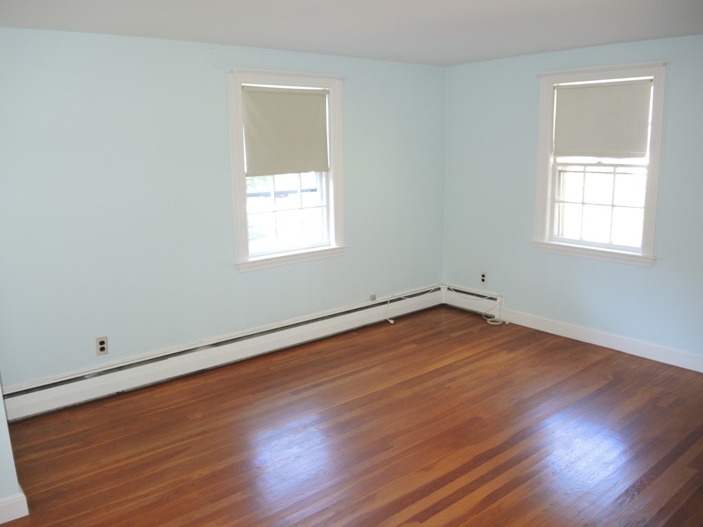 58 Avalon Road Needham, MA 02492 - Photo 12 of 22 an empty room with wooden floor and windows