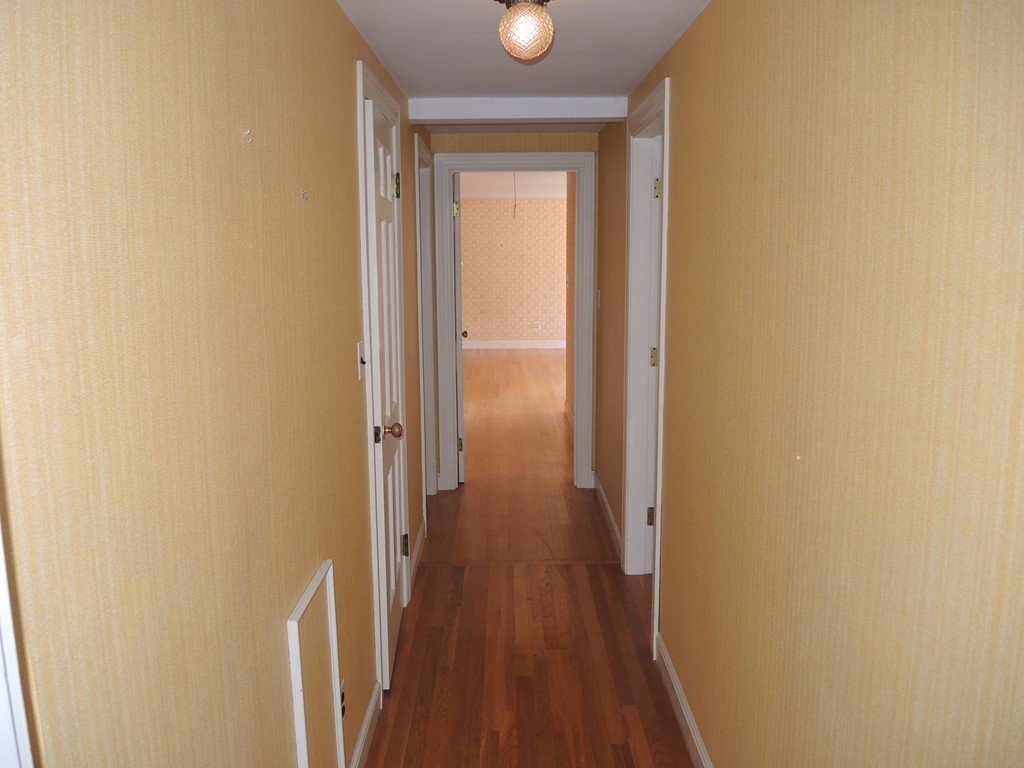 58 Avalon Road Needham, MA 02492 - Photo 14 of 22 a view of a hallway with wooden floor