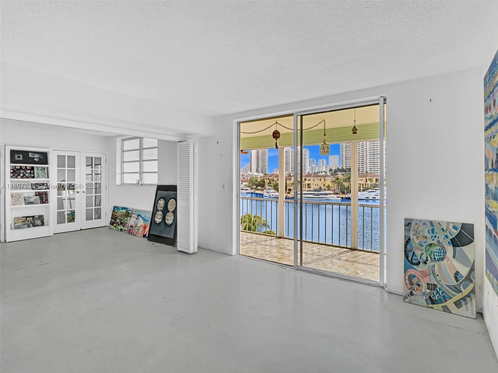 2980 Point E Drive, Unit D508 Aventura, FL 33160 - Photo 11 of 53 a view of an empty room with floor to ceiling window and wooden floor