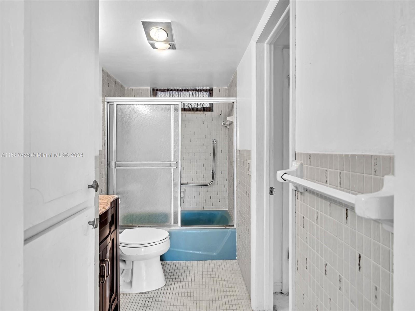 2980 Point E Drive, Unit D508 Aventura, FL 33160 - Photo 19 of 53 a bathroom with a granite countertop shower a toilet and a sink