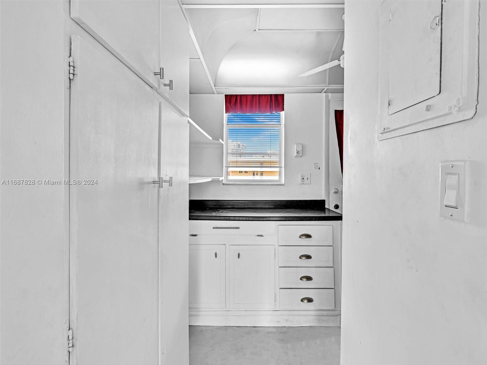 2980 Point E Drive, Unit D508 Aventura, FL 33160 - Photo 22 of 53 a kitchen with white cabinets and window