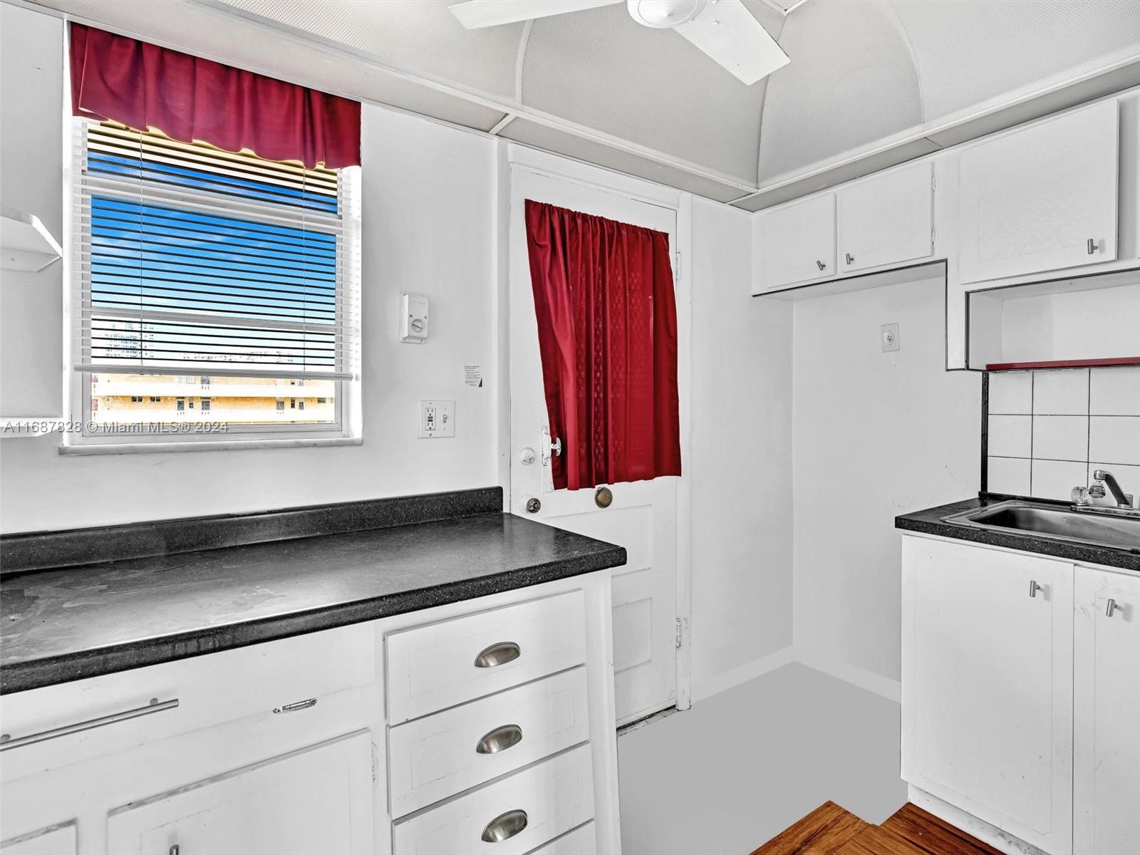 2980 Point E Drive, Unit D508 Aventura, FL 33160 - Photo 23 of 53 a view of kitchen with granite countertop white cabinets and black appliances