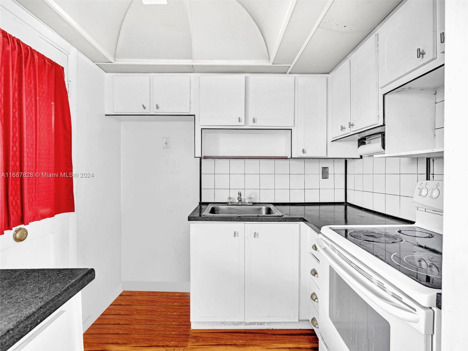 2980 Point E Drive, Unit D508 Aventura, FL 33160 - Photo 25 of 53 a kitchen with granite countertop a sink a stove and cabinets