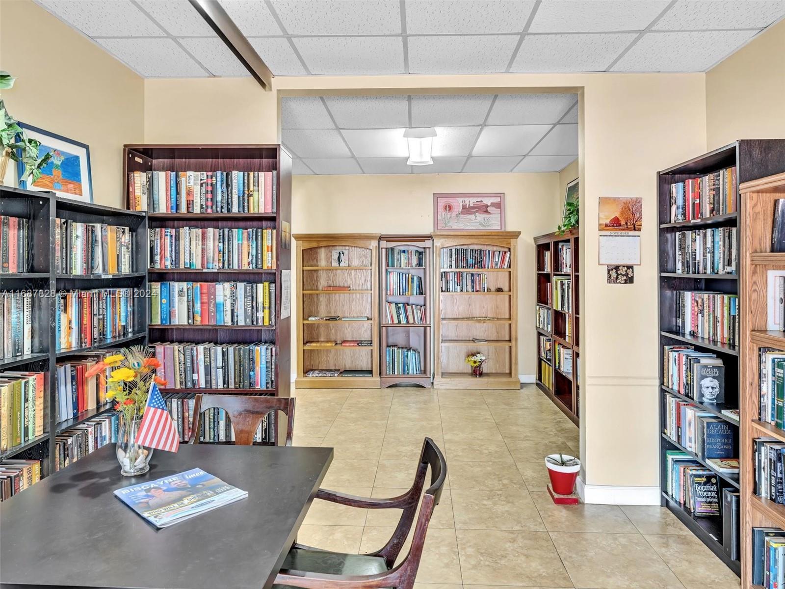 2980 Point E Drive, Unit D508 Aventura, FL 33160 - Photo 35 of 53 a living room with lots of books cabinets and a book shelf