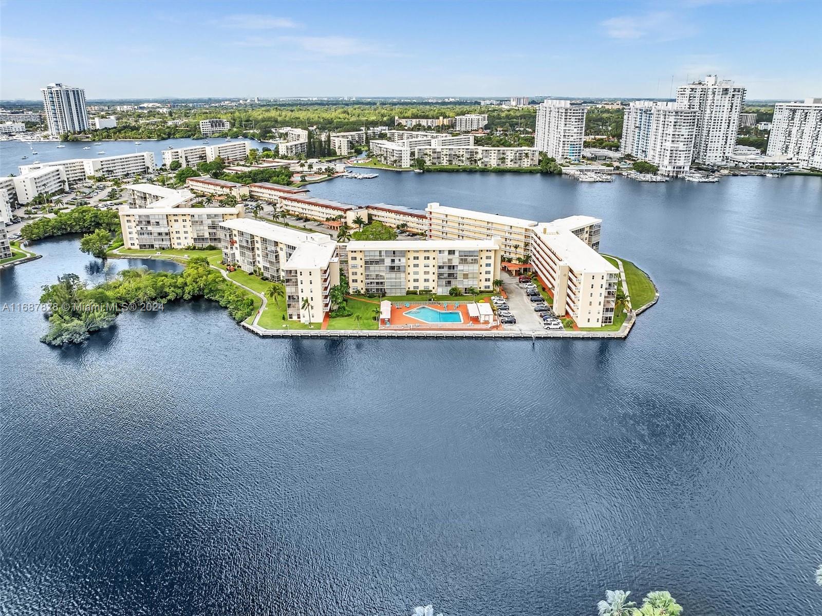 2980 Point E Drive, Unit D508 Aventura, FL 33160 - Photo 42 of 53 a view of a lake with tall buildings