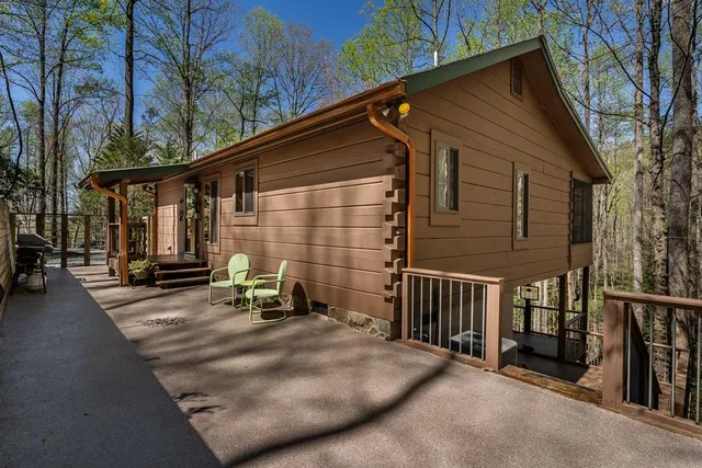 a view of a house with backyard and sitting area
