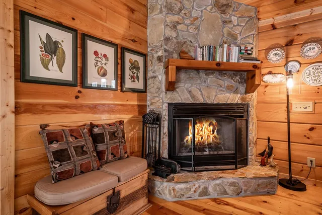 a living room with furniture a fireplace and a black door