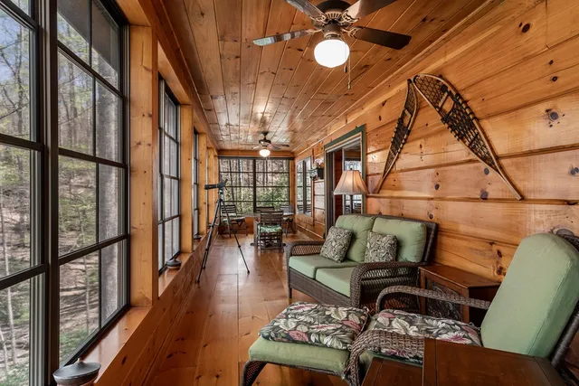 a living room with furniture and a floor to ceiling window
