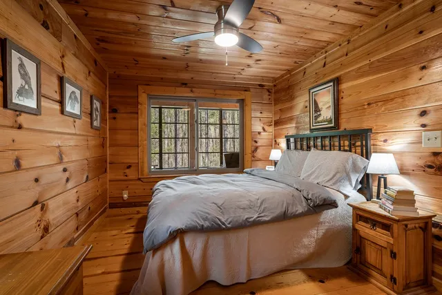 a bed sitting in a bedroom next to a window