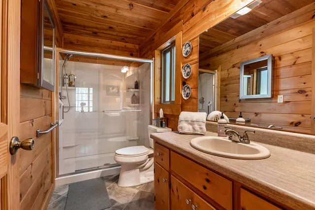 a bathroom with a sink toilet and shower