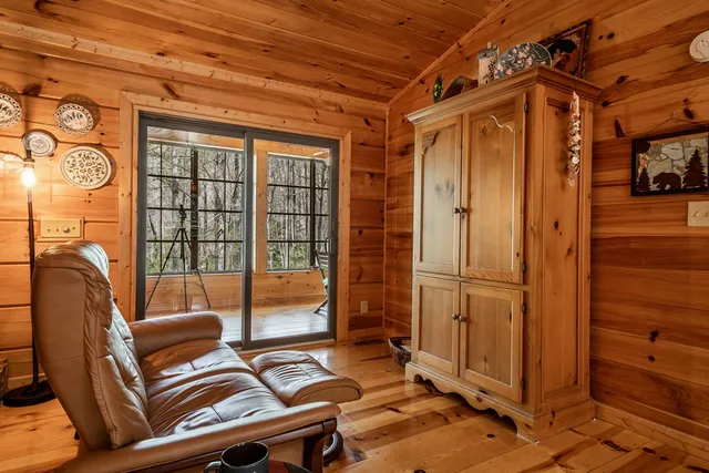 a bedroom with furniture and large windows