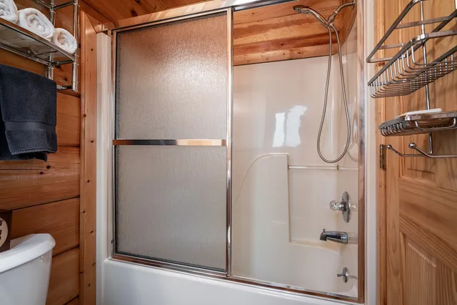 a bathroom that has a glass shower door