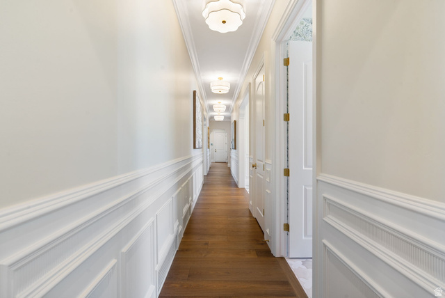 115 East Hidden Ridge Lane, Unit 42 Mapleton, UT 84664 - Photo 35 of 103 Hallway featuring wood-finish flooring, white wainscoting, crown molding, and multiple flush-mount ceiling lights