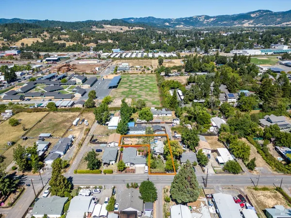 an aerial view of residential houses with outdoor space