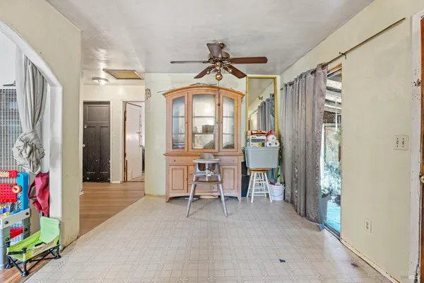 a view of a hallway with furniture and a chandelier