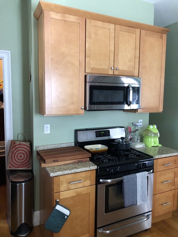27 Warren Avenue, Unit 1 Somerville, MA 02143 - Photo 15 of 18 a kitchen with a stove and a microwave