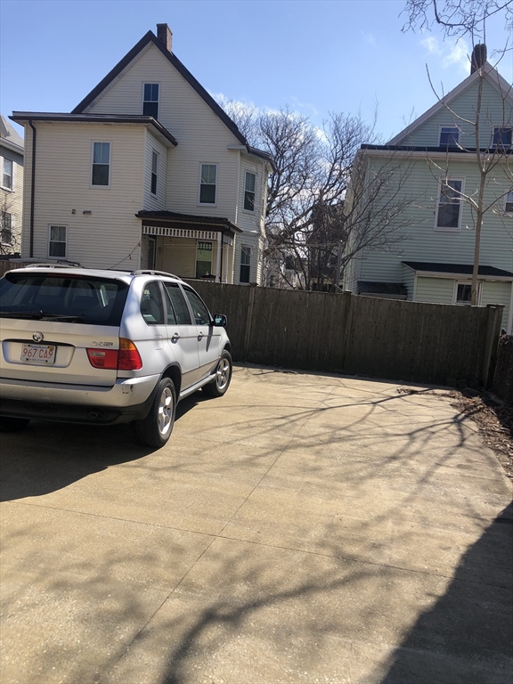 27 Warren Avenue, Unit 1 Somerville, MA 02143 - Photo 3 of 18 a white building covered with snow in front of house